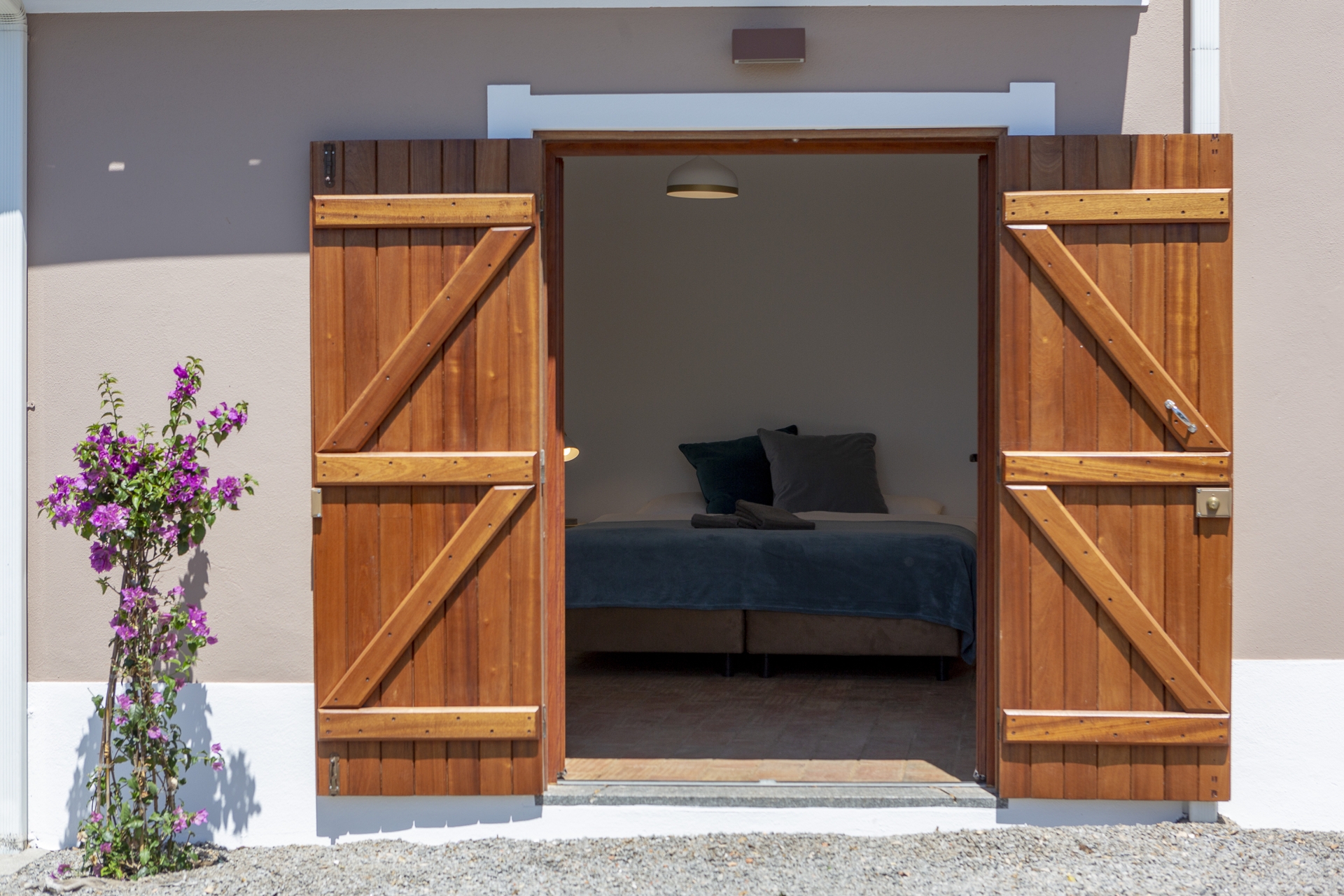 Guest room with open wooden doors at Bodhi Bhavan
