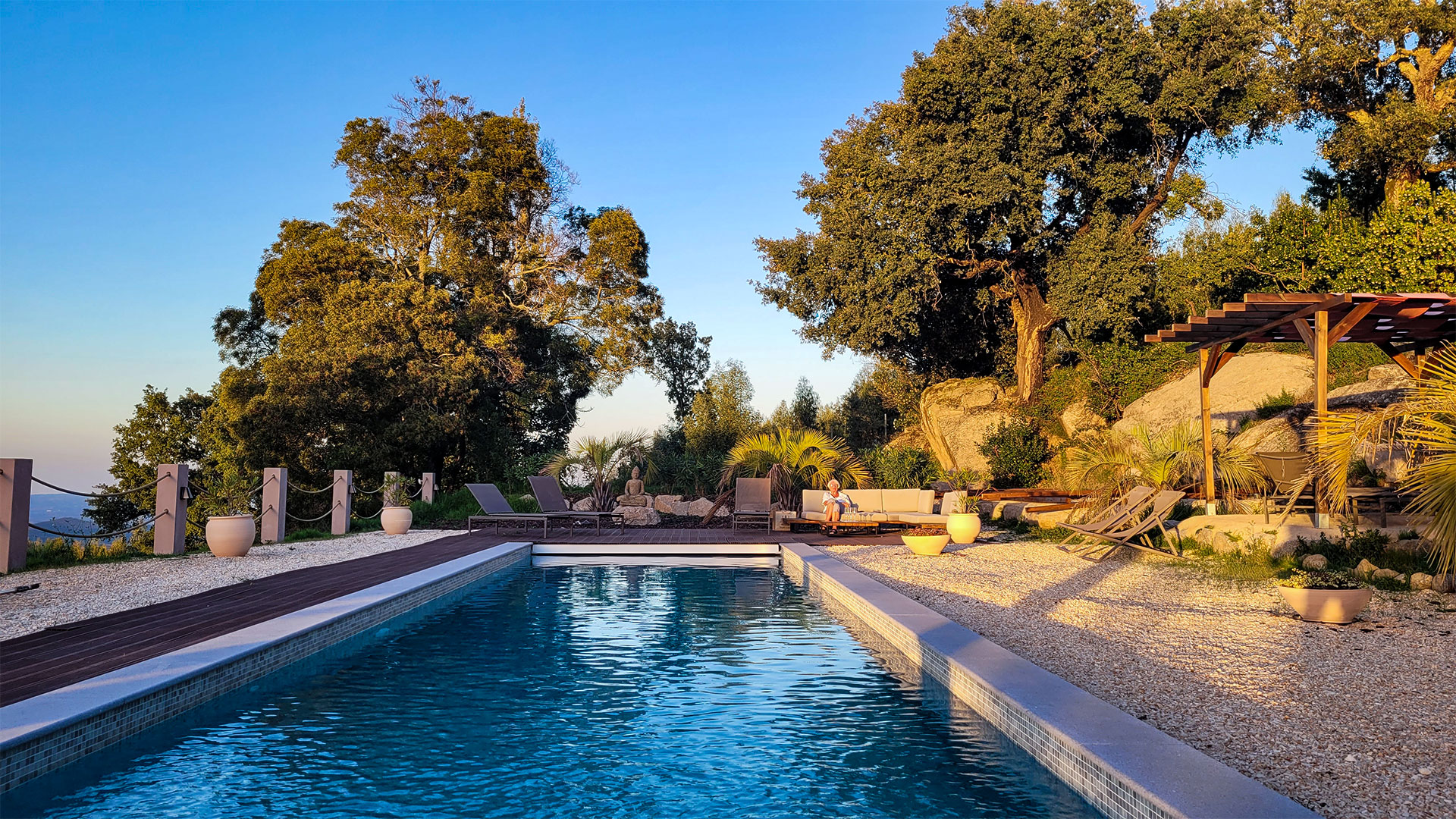 Swimming pool and lounge area at golden hour, Bodhi Bhavan